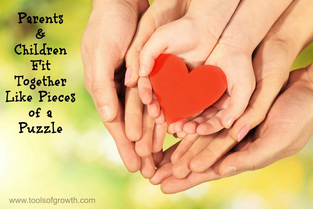 Red heart in family hands on bright background